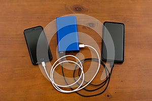 Charge sharing- recharging two cellphones with one blue power bank