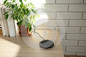 Charged wirelessly device at modern domestic room, indoors. Advanced technology