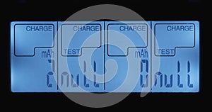 Charger display close-up. Flashing CHARGE symbol, voltage 1.28 volts.