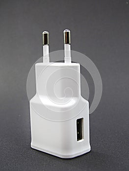 Charging adapter for smart phones on black background