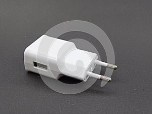 Charging adapter for smart phones on black background