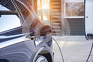 Charging an electric car at a car repair shop service garage. Refueling for electric cars e-mobility