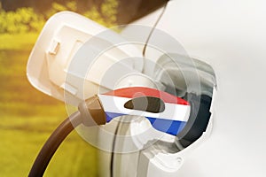 Charging electric vehicles with an electric cable with the image of the flag of the Netherlands