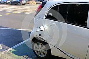 Charging full electric car on public charge station in the city street