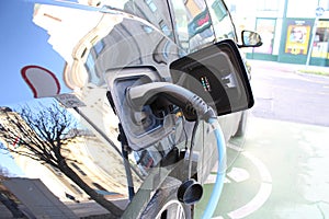 Charging full electric car on public charge station in the city street