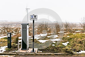 Charging Point For Electric Cars with a Wind Farm in Background