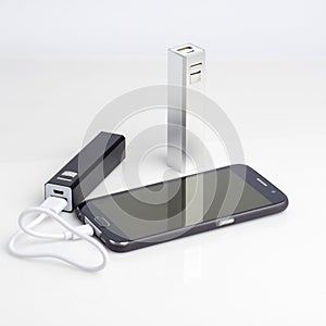 Charging a smartphone from powerbank on white