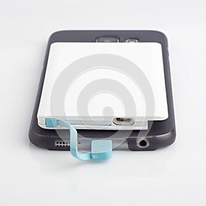 Charging a smartphone from powerbank on white