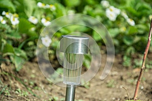 Charging solar lamp on the ground in the garden