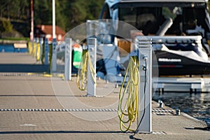 Charging station for boats, electrical outlets to charge sailboats in empty harbor of marina