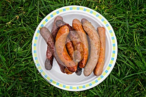 Chargrilled sausages piled on a plate photo