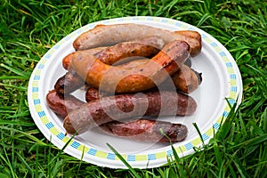 Chargrilled sausages piled on a plate