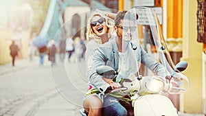 Charimgn lady riding a retro scooter with her boyfriend photo