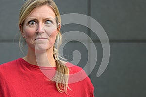 Charismatic blond woman with wide staring eyes