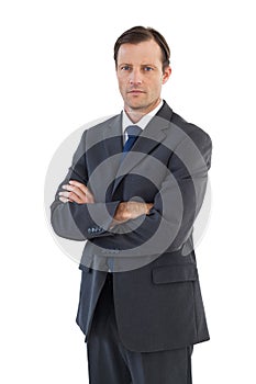 Charismatic businessman standing with arms crossed