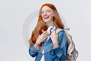 Charismatic and cheerful, lovely friendly redhead girl laughing over girlfriend joke as heading back campus from