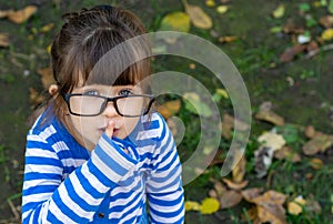 Charismatic child showing shush gesture hiding secret preparing surprise standing friendly and enthusiastic,