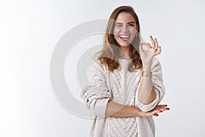 Charismatic confident upbeat gorgeous adult woman wearing loose stylish sweater cozy, winking flirty sassy smiling