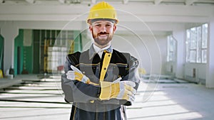 Charismatic construction worker man at construction site wearing special uniform and safety helmet he posing to the