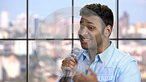 Charismatic entertainer talking into microphone.