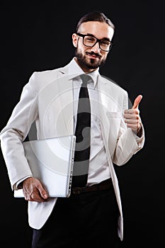 Charismatic guy in a suit with ntebook