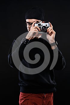 Charismatic guy in sweater , glasses photo camera