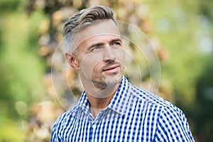 Charismatic male has well groomed graying hair, beauty