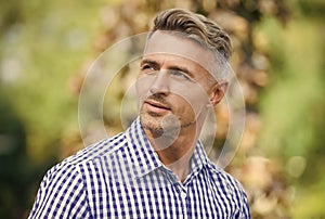 charismatic male has well groomed graying hair, beauty