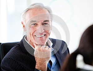 Charismatic senior businessman in a meeting