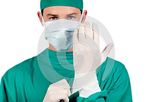 Charismatic surgeon wearing surgical gloves photo