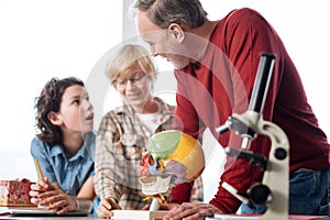 Charismatic talented teacher engaging his students in biology