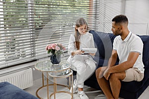 Charismatic woman doctor have a conversation with her patient man they discussing about his results on the x-ray while