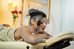Charismatic young woman enjoying her massage, closeup shot