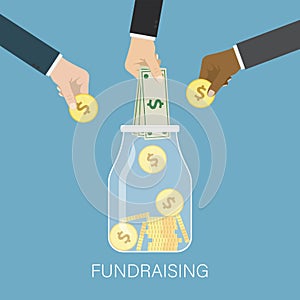 Charity donation, fundraising, social responsibility. Different hands puts money in glass jar. Crowdfunding concept. Various