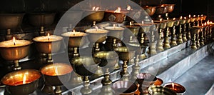 Charity. Praying candles in a monastery in Bhutan.