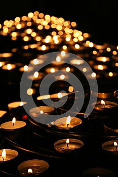 Charity. Praying candles in a temple.