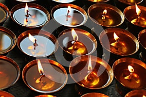 Charity. Praying candles in a temple.