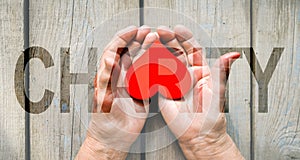 Charity Transparent Text Effect, old and young hands, red heart image cut, white background.