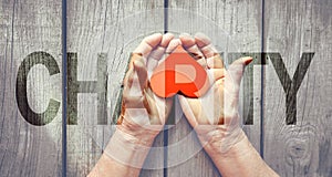 Charity Transparent Text Effect, old and young hands, red heart image cut, white background.