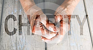 Charity Transparent Text Effect, old and young hands, red heart image cut, white background.