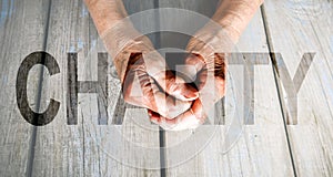 Charity Transparent Text Effect, old and young hands, red heart image cut, white background.