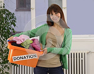 Charity: Woman with clothing donation box photo