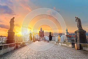 Charles Bridge Karluv Most and Old Town Tower at amazing sunrise with sky and clouds in Prague, Czech Republic photo