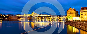 Charles Bridge over Vltava river in Prague, Czech Republic. Night with touristic boats