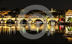 Charles bridge over Vltava river, in Prague, night photo
