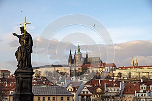 Charles Bridge Statue with shiny cross & St Vitus Cathedral