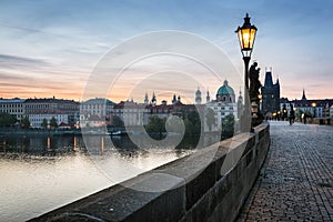 Charles Bridge at sunrise, Prague, Czech Republic. Dramatic statues and medieval towers.