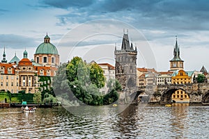 Charles Bridge,tourist boat on Vltava river,Prague, Czech Republic. Buildings and landmarks of Old town on summer day. Amazing