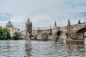 Charles Bridge,tourist boat on Vltava river,Prague, Czech Republic. Buildings and landmarks of Old town on summer day. Amazing