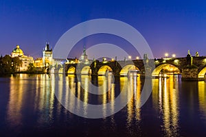 Charles Bridge and Vltava river in Prague in dusk at sunset